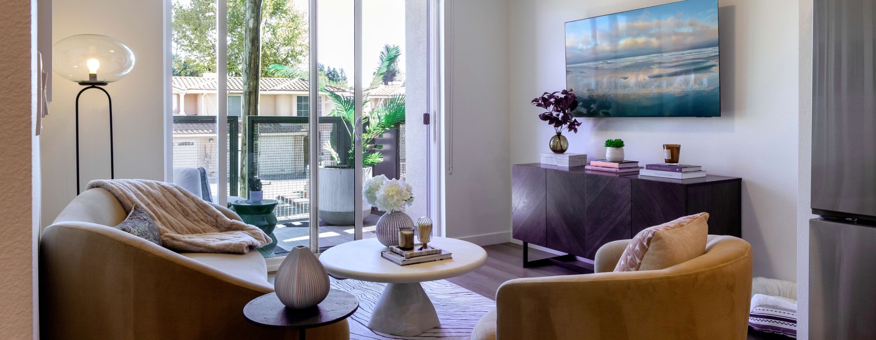 living room with couch, chair and coffee table and tv on the wall