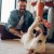 a couple playing with a dog