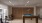 a pool table in a room with seating and tables