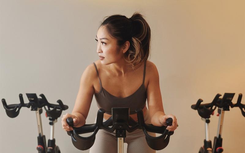 a woman riding a stationary bike