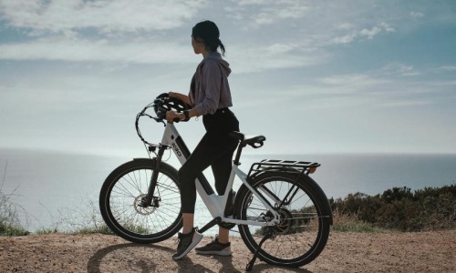 A beautiful community at the heart of all your passions a woman standing next to a bicycle