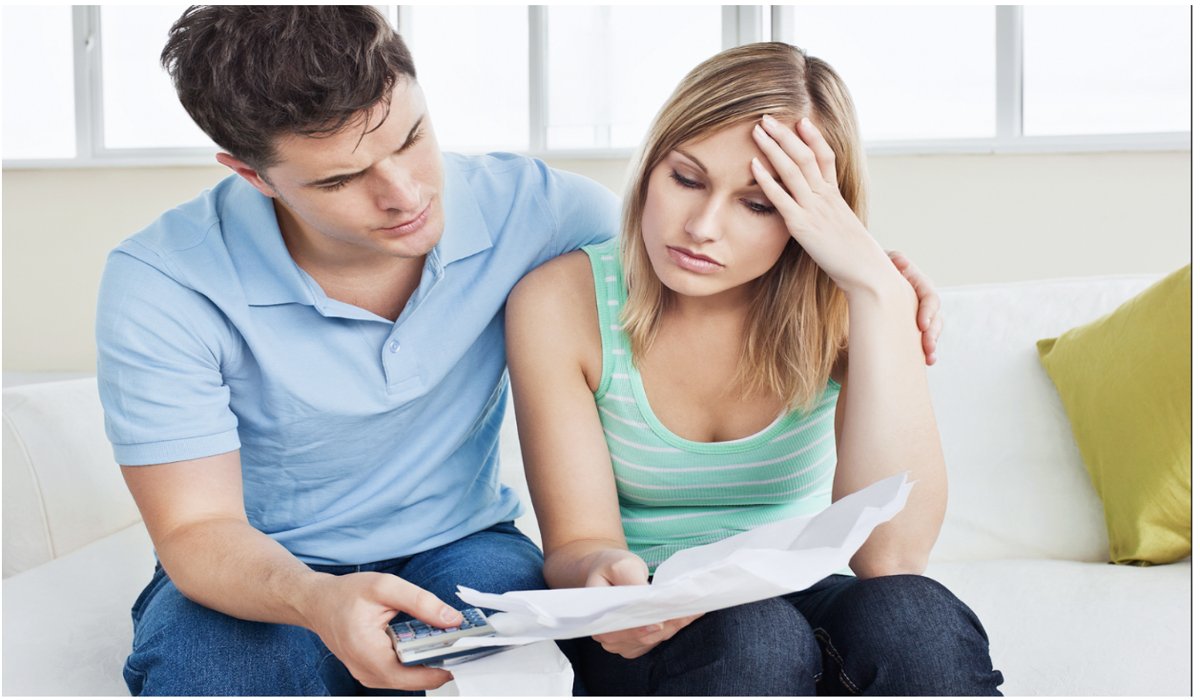 Couple discussing credit check for renting in Los Angeles. Couple calculating rent payments and credit score concerns while applying for an apartment in Los Angeles at Pendant on Topanga